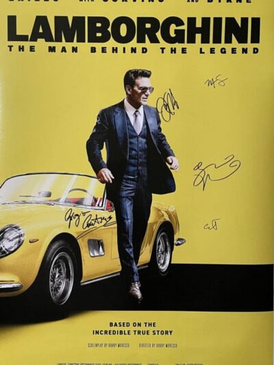 Man in suit beside yellow Lamborghini car.