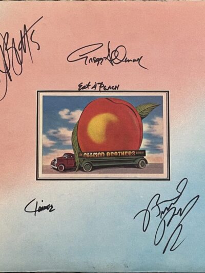 Album cover with a peach and signatures.