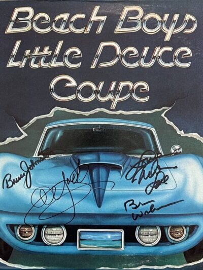 Blue car with "Beach Boys" album cover.