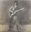 Guitarist on "Blow by Blow" album cover.