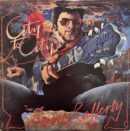 Man with guitar on colorful album cover.
