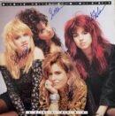Four women posing with autographs