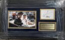 Framed wedding photo with autographs and plaque.