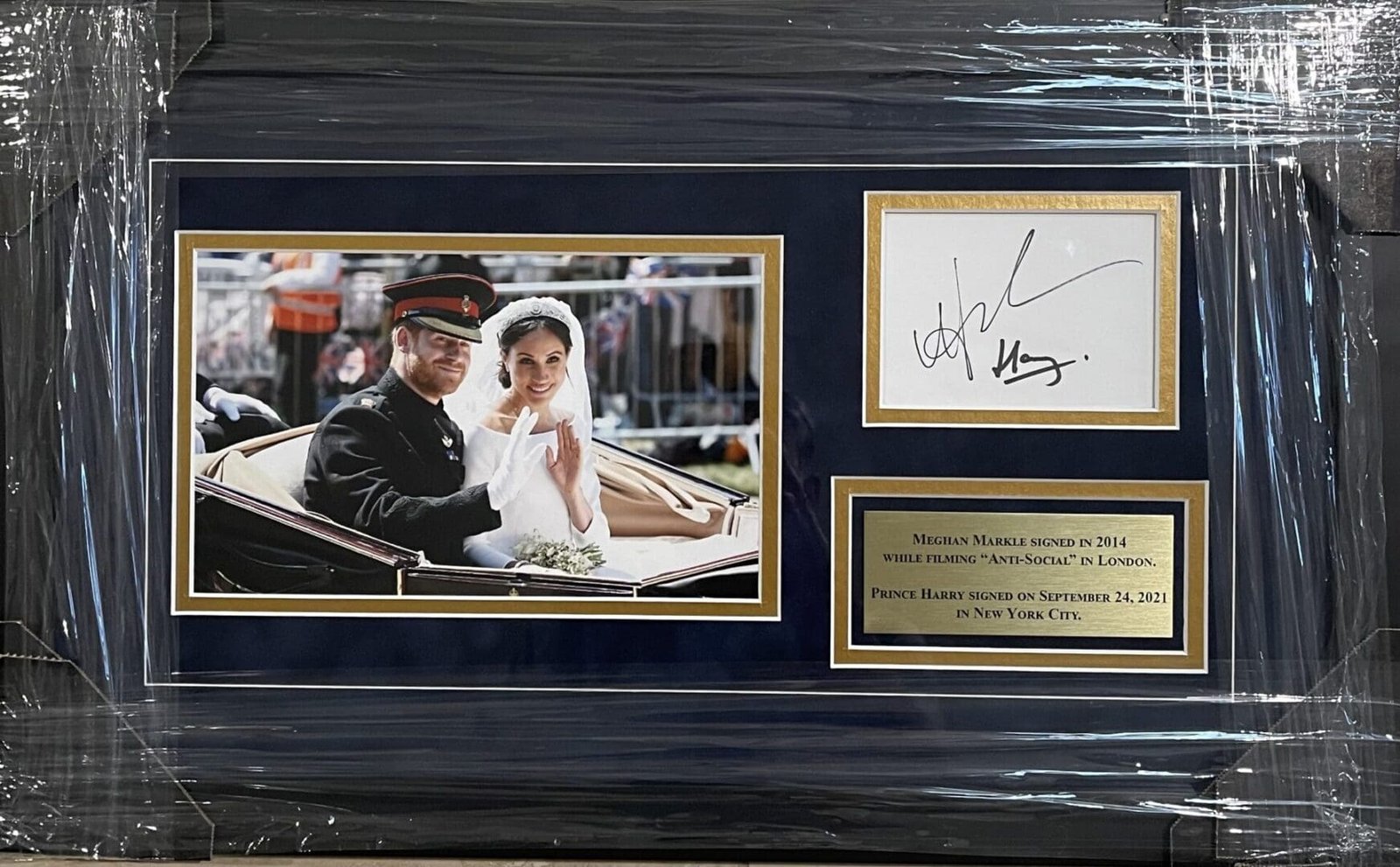 Framed wedding photo with autographs and plaque.