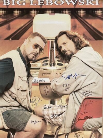 Two men seated in a bowling alley.