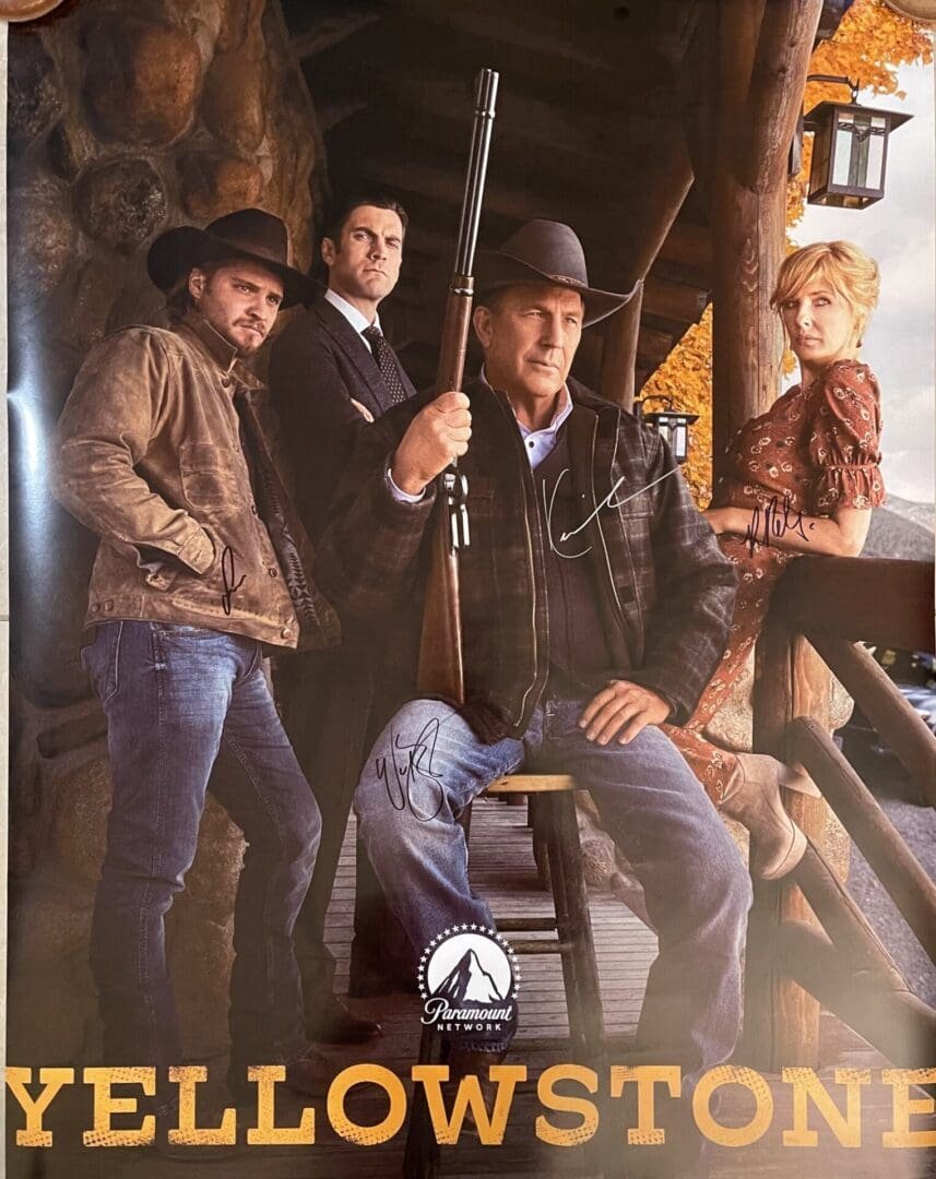 Four people posing in rustic setting.