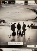 U2 album poster with band signatures.
