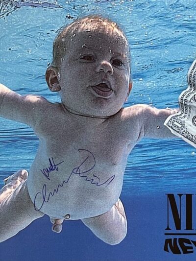 Baby swimming underwater towards dollar bill.