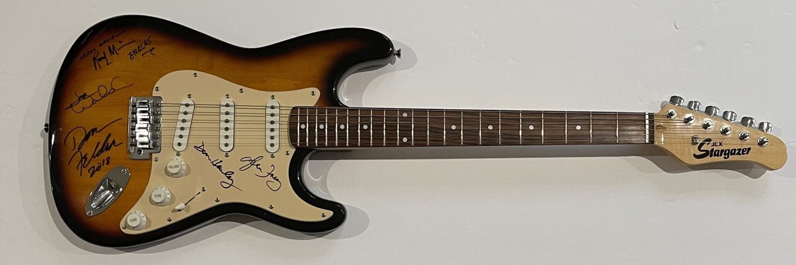 Electric guitar with signatures on the body.