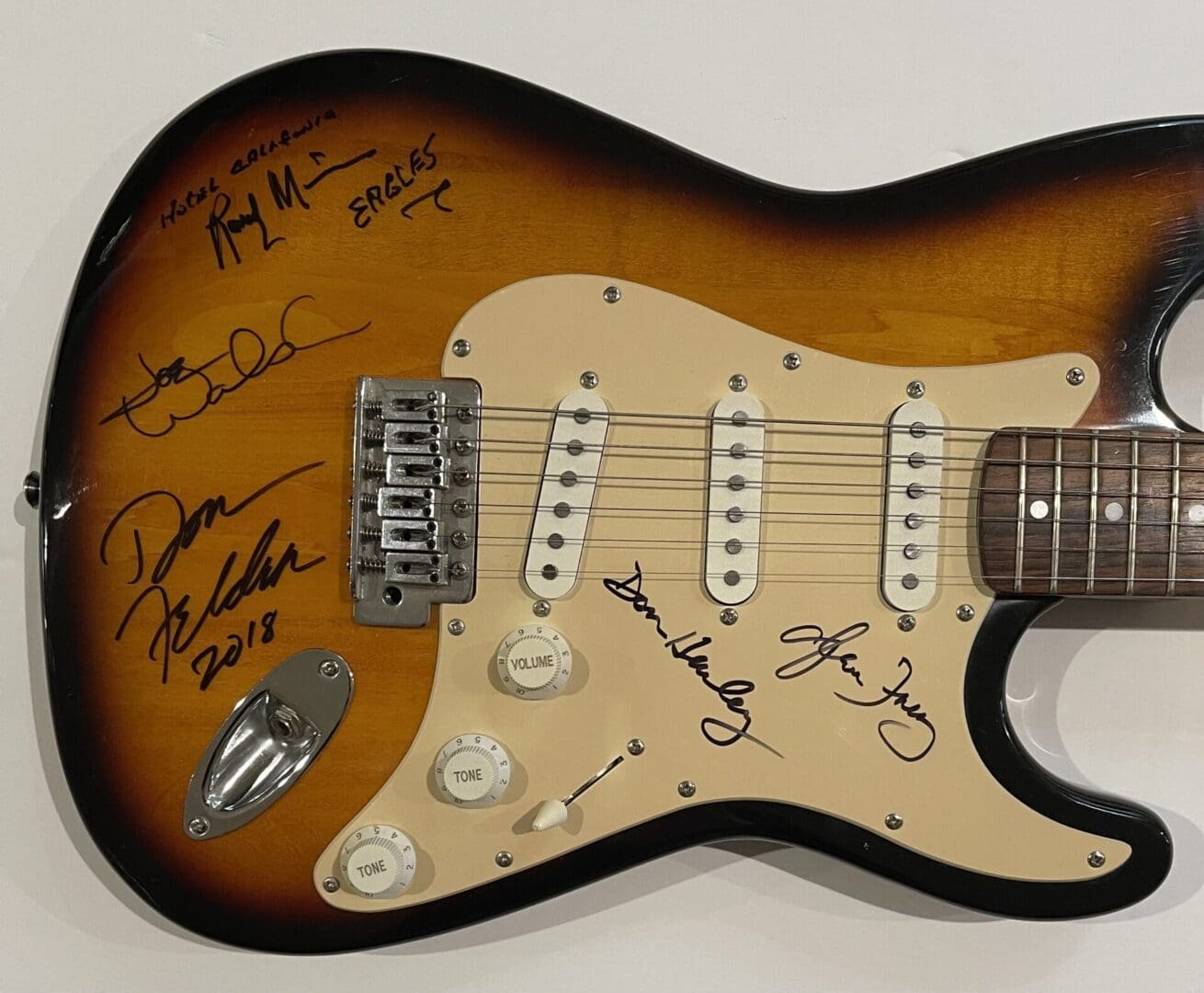 Autographed electric guitar with sunburst finish.