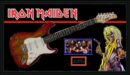 Iron Maiden guitar with band photo and mascot.