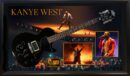 Framed Kanye West memorabilia with guitar and photos.