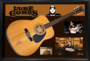 Acoustic guitar with musician-themed collage background.