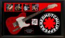 Red guitar with Red Hot Chili Peppers memorabilia.