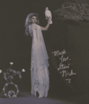 Woman in white holding a white bird.