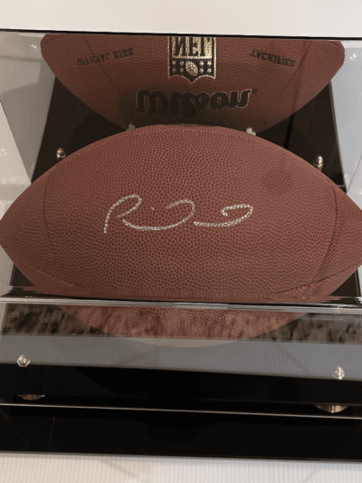 Signed football in a display case.