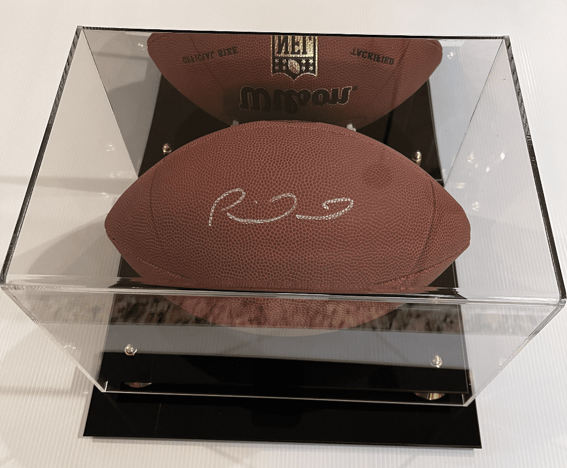 Signed football in a display case.