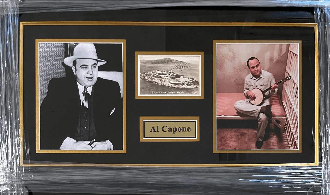 Framed Al Capone photos and memorabilia display.
