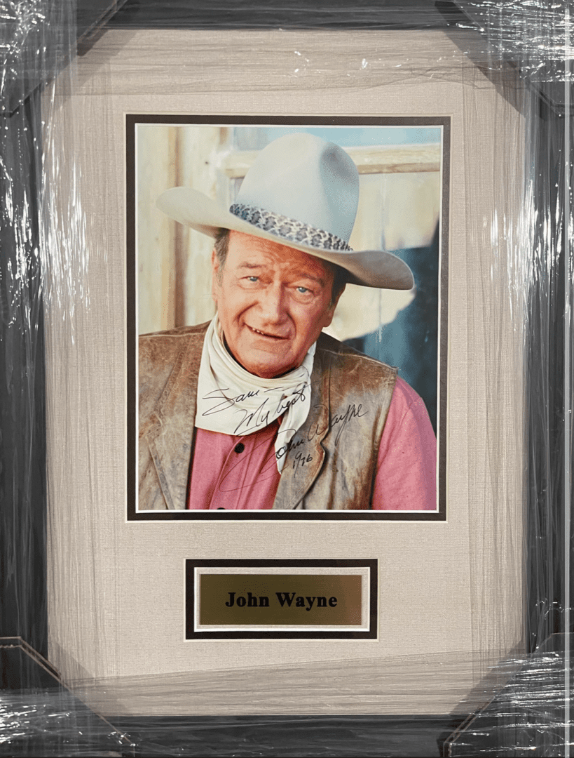 Framed portrait of a man in cowboy attire.