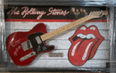 Red electric guitar with Rolling Stones logo.