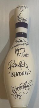 Signed bowling pin with various autographs.