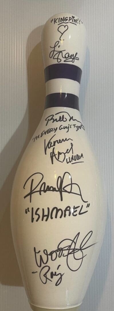 Signed bowling pin with various autographs.