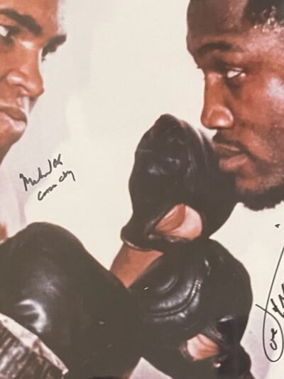 Two boxers facing off in signed photograph.