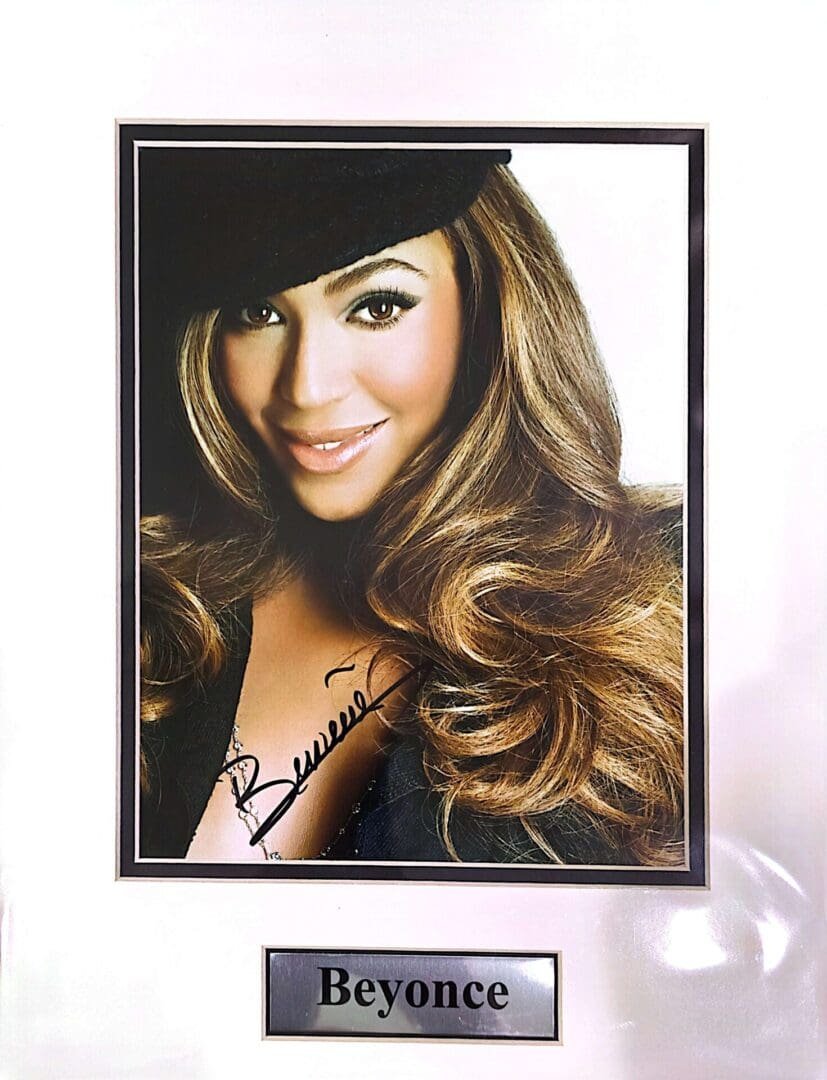 Smiling woman with long hair and hat.