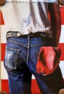 Jeans and cap against American flag background.