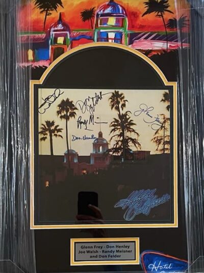 Framed artwork with signatures and colorful background.
