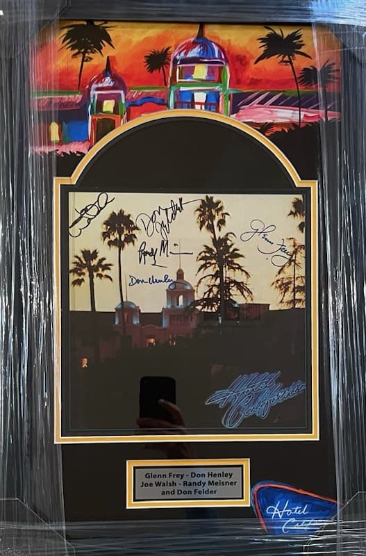 Framed artwork with signatures and colorful background.