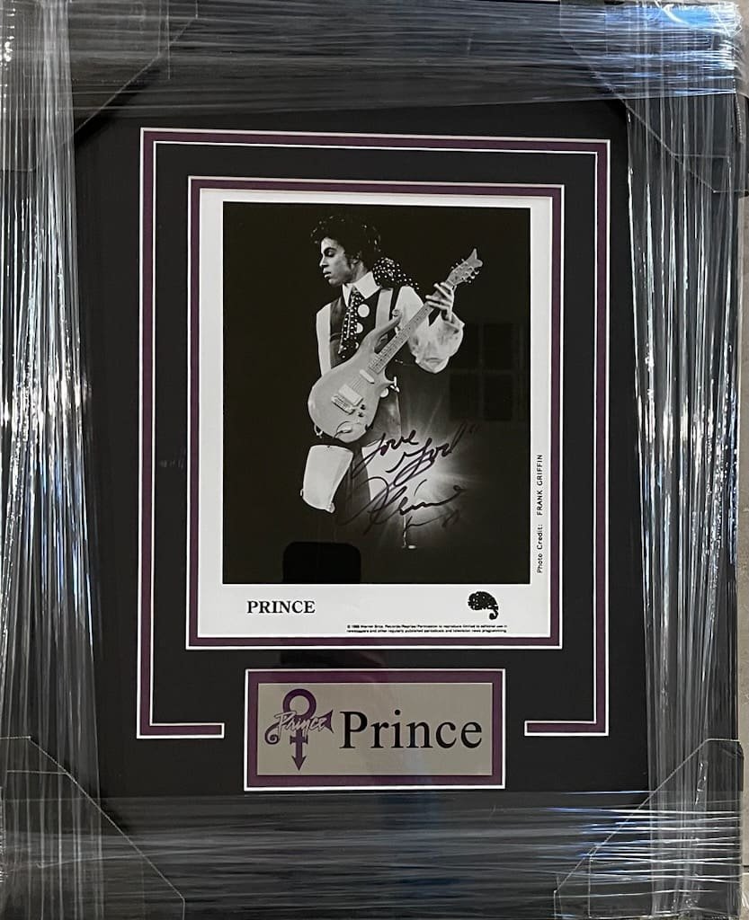 Framed photograph of musician with guitar.