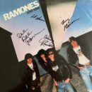 Autographed punk album cover with four band members