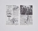Signed music magazine page with band photo.