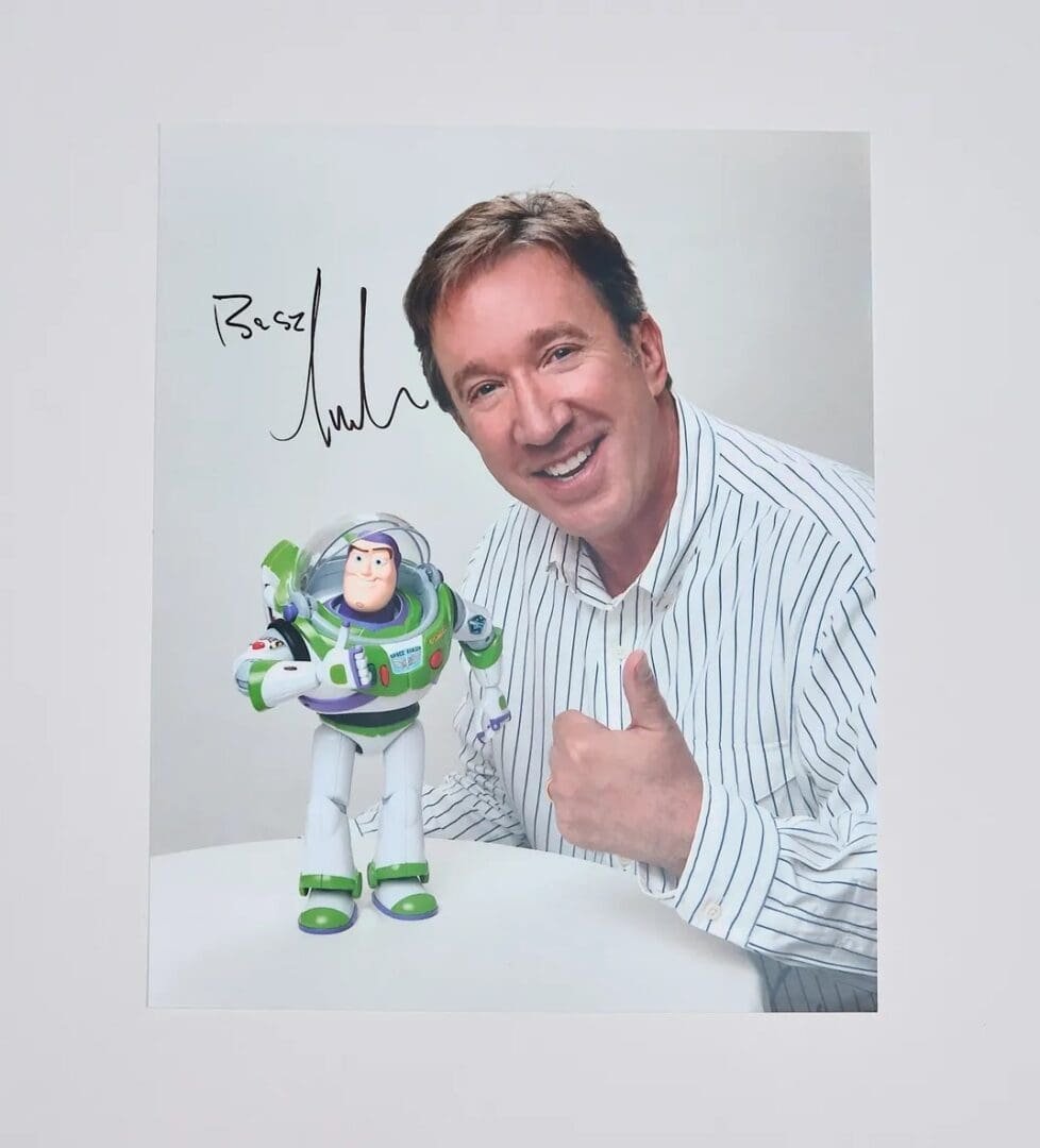 Man smiling with Buzz Lightyear toy