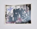 Autographed vintage group photo of people.