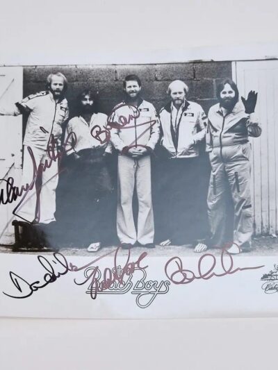 Black-and-white photo of five men signed.
