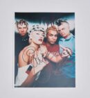Autographed photo of a four-member band.