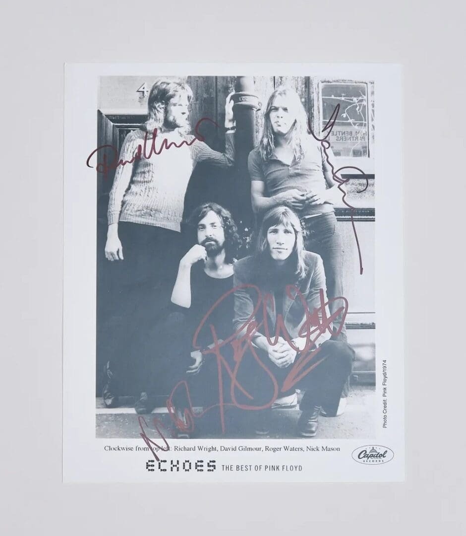 Black and white band photo with signatures.