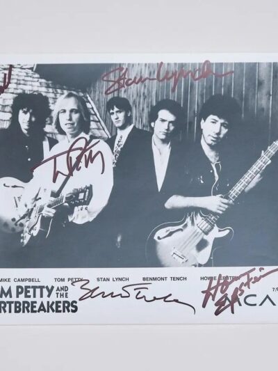 Black and white band photo with signatures.