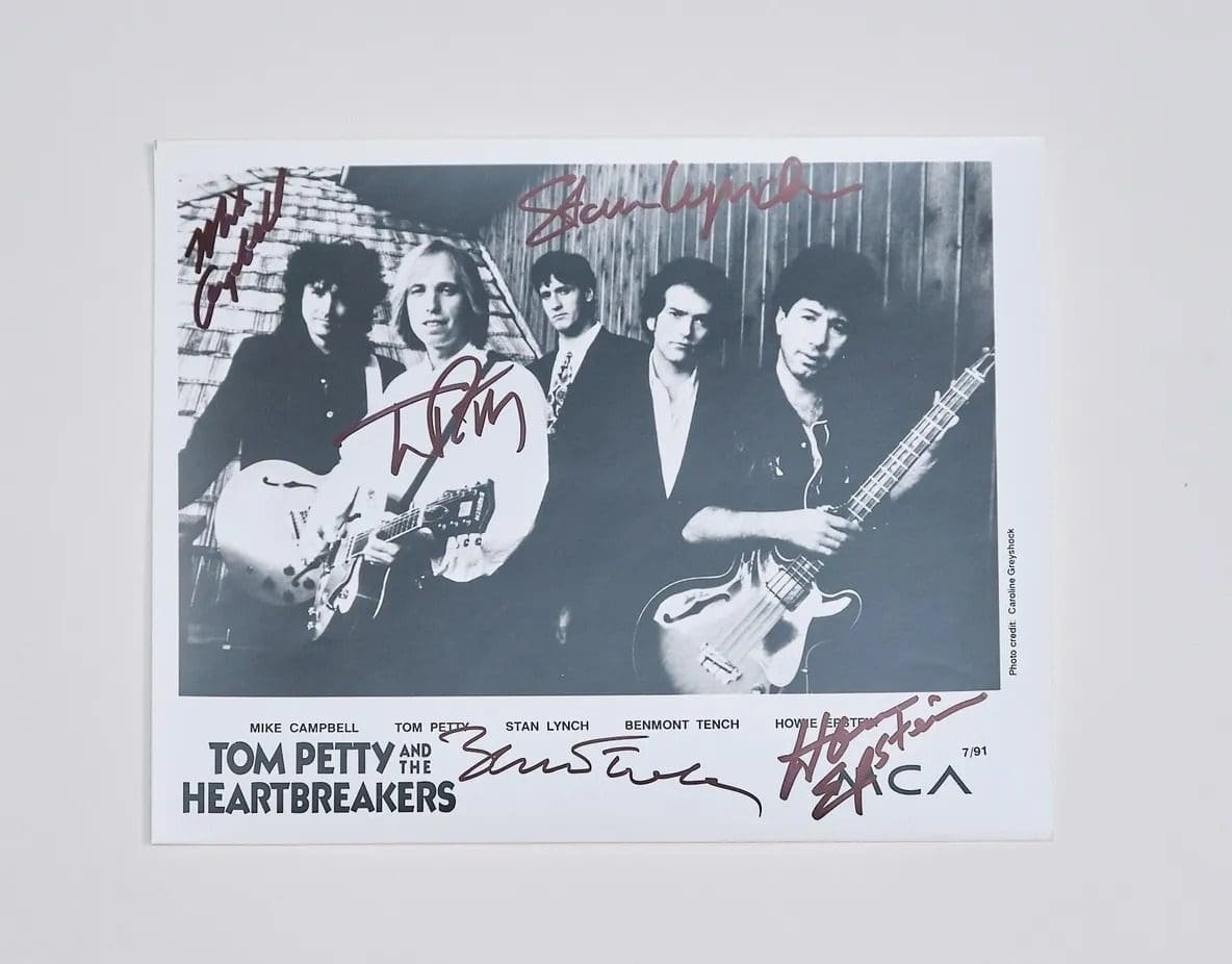 Black and white band photo with signatures.