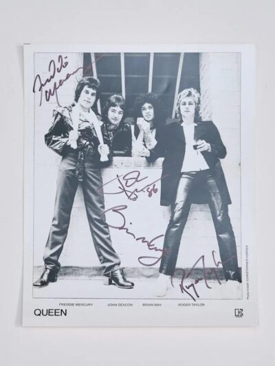 Black and white signed photo of band.