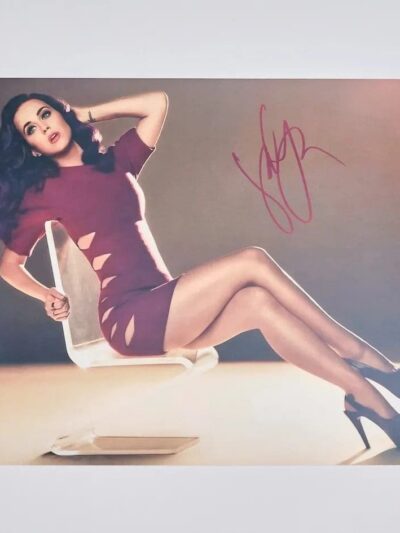 Woman in red dress sitting on chair.