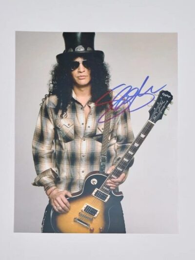 Musician with guitar and top hat posing.
