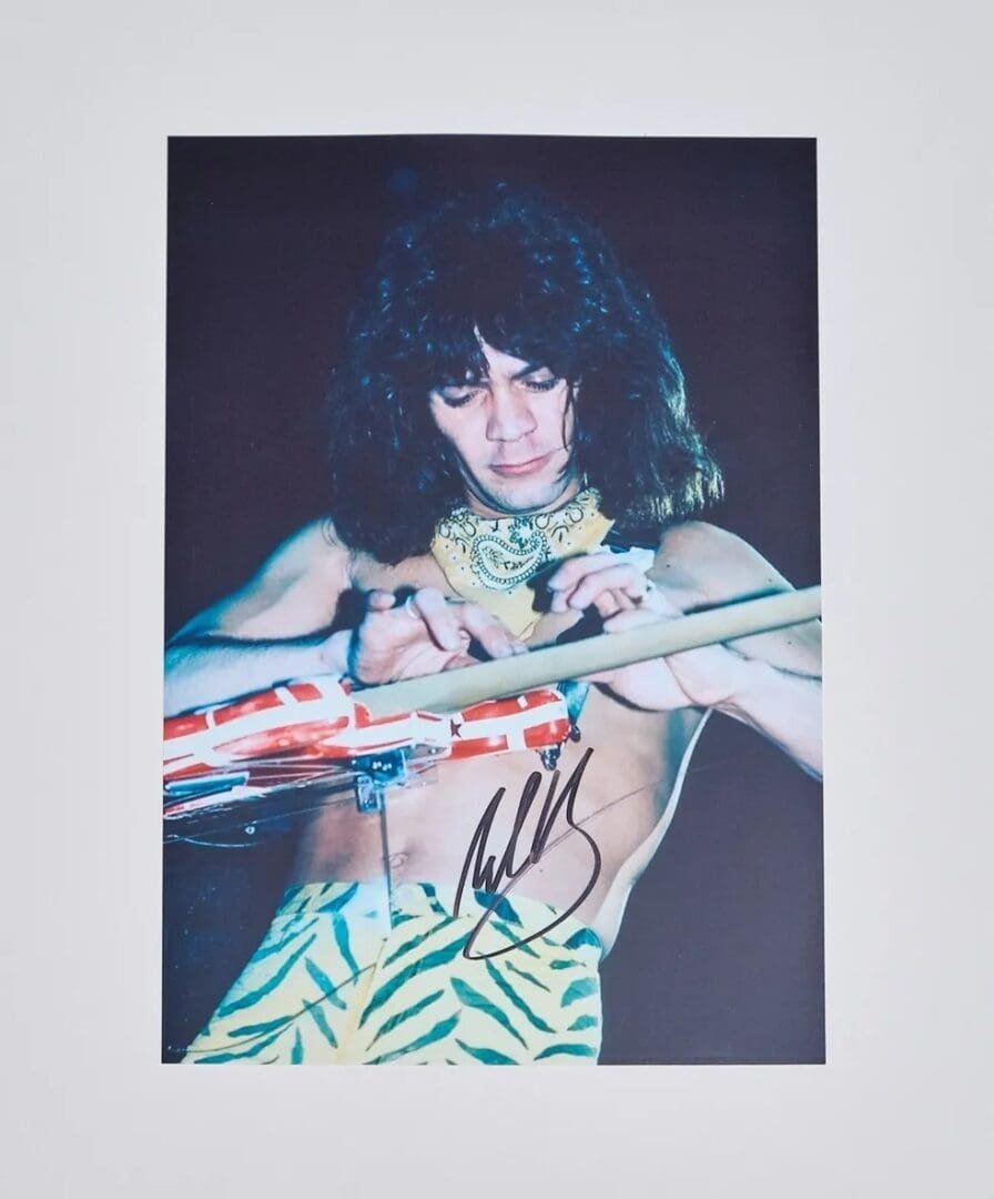 Musician playing guitar with zebra-patterned pants.