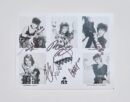 Black-and-white signed band member portraits.