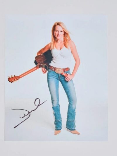 Woman with guitar and autograph on photo.