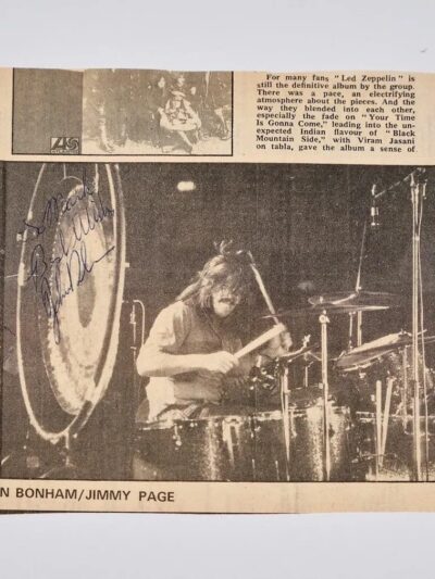 Newspaper clipping of a drummer performing live.