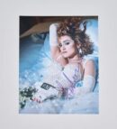 Woman in lace dress lying on bed.