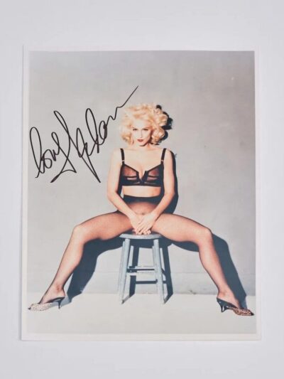 Blonde woman sitting on stool in lingerie.